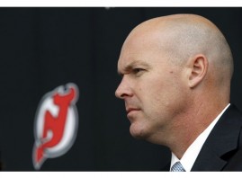 John Maclean, Head Coach of New Jersey Devils NHL hockey team, looks on at news conference to announce signing of player Ilya Kovalchuk to long-term contract with team in Newark